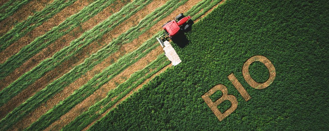 tractor in field with lettering organic
